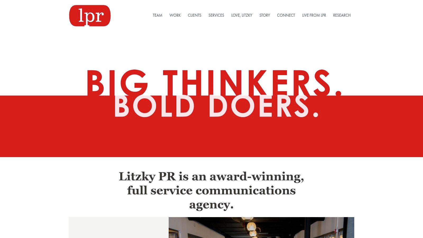 A team of professionals collaborating around a table in a modern office, representing the strategic work of a PR agency like Litzky.