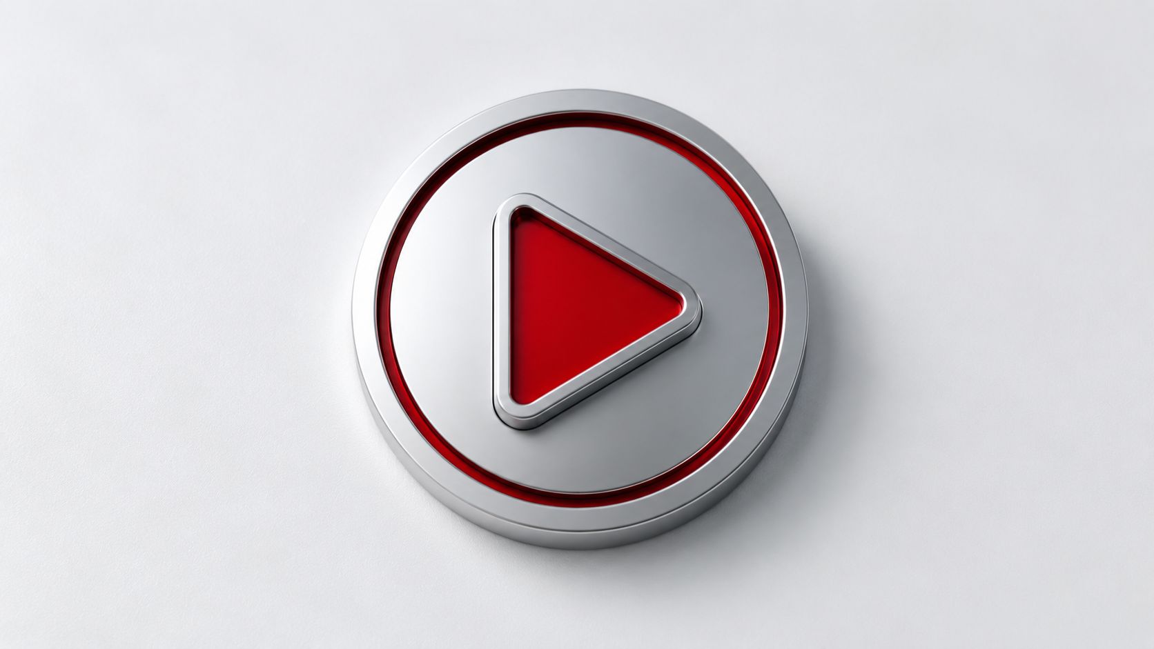 A 3D metallic play button icon with a red center set against a clean white background.